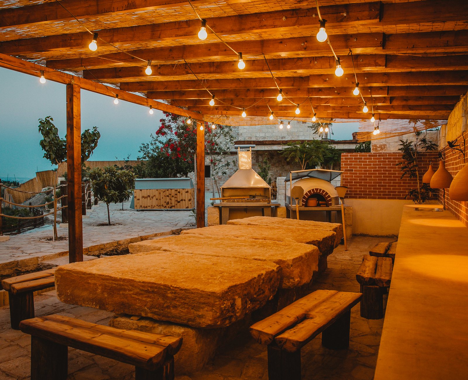 Mediterranean gardens with stone courtyard set for a wedding dinner
